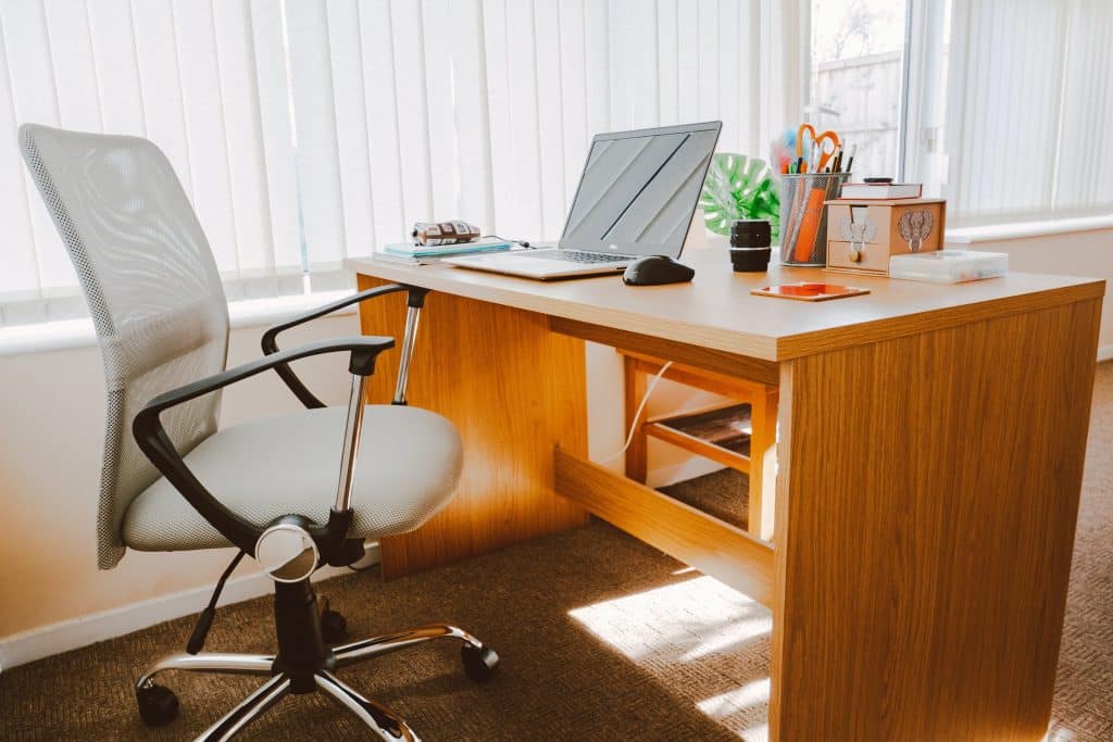 A brightly coloured office desk in a well lit office